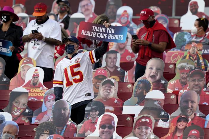 A fan holds up a sign honoring heart care workers before the NFL Super Bowl 55 football game between the Kansas City Chiefs and Tampa Bay Buccaneers, Sunday, Feb. 7, 2021, in Tampa, Fla. (AP Photo/Lynne Sladky)