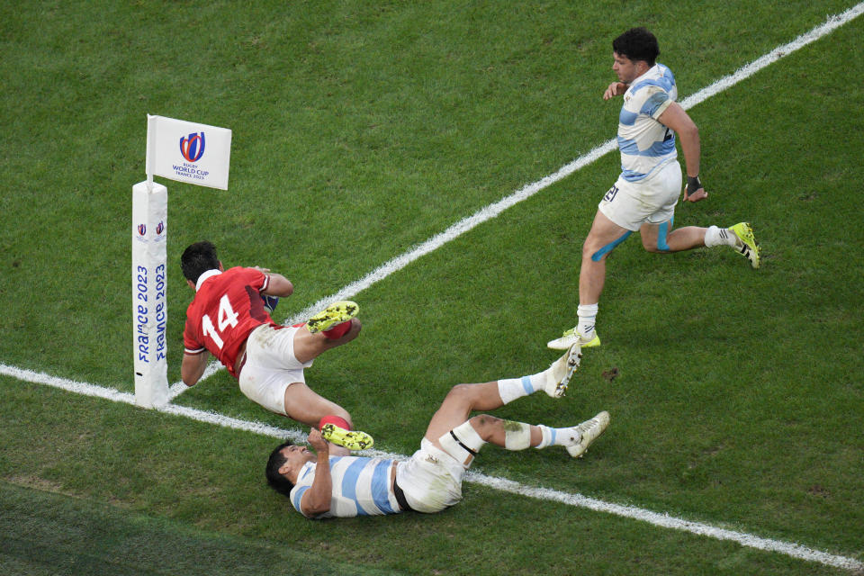 Argentina's Matias Moroni tackles Wales' Louis Rees-Zammit during the Rugby World Cup quarterfinal match between Wales and Argentina at the Stade de Marseille in Marseille, France, Saturday, Oct. 14, 2023. (AP Photo/Daniel Cole)