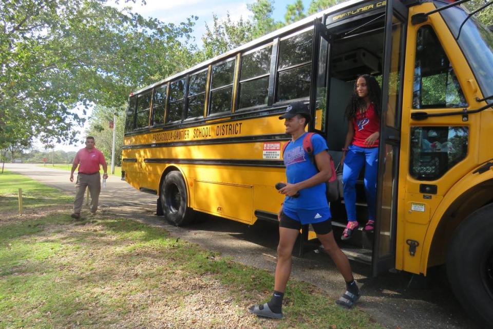 Captains Joseph Muniz and Leandra Ruiz get off the bus at the regional cross country meet in George County on Oct. 26, 2021.