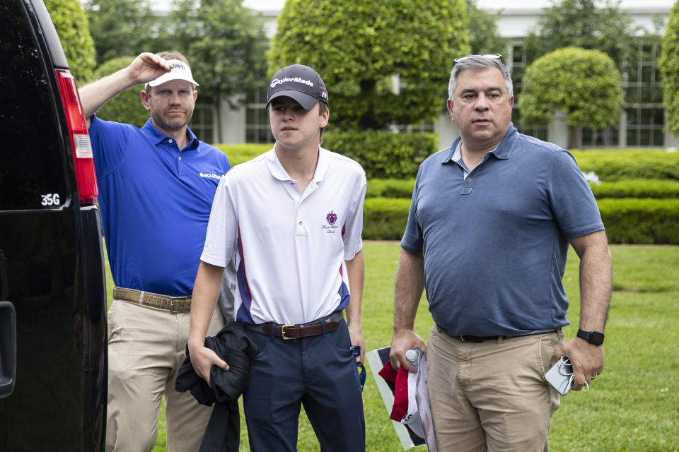 Pro golfer Billy Hurley III, left, and others stand after returning to the White House from his Trump National Golf Club with President Donald Trump, Sunday, May 24, 2020, in Washington. (AP Photo/Alex Brandon)