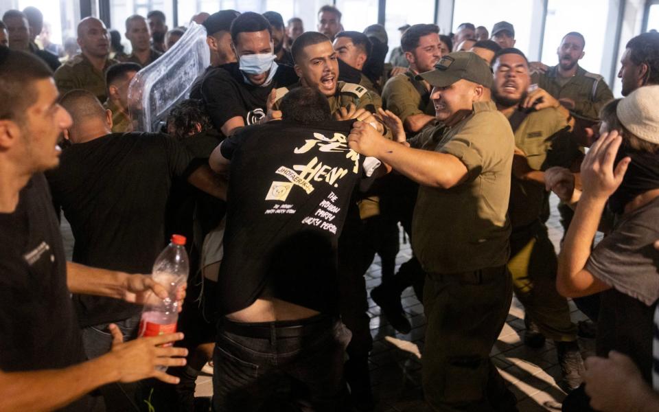Israeli soldiers and police clash with right-Wing protesters after they broke into the Beit Lid army base last night