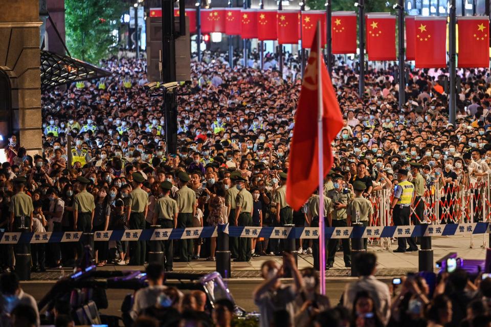 Shanghai crowd watching chinese communist party anniversary light show