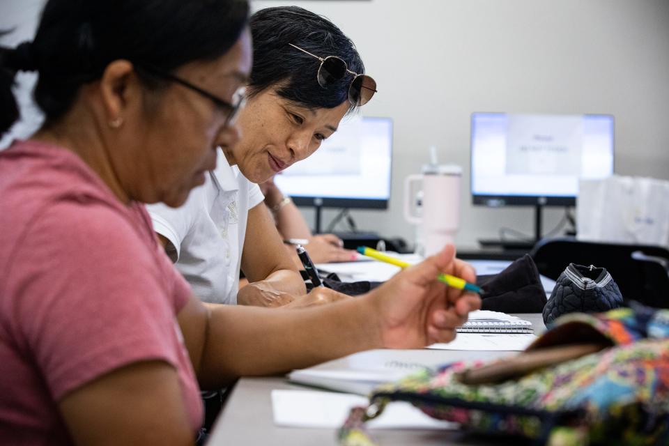 Emi Shinoda, from Japan, and Maria Rangel, from Mexico, take notes during a Literacy for Caregivers English class on Wednesday, Aug. 23, 2023, in Corpus Christi, Texas.