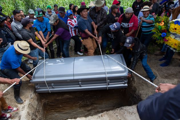 Neighbors and relatives lower the coffin that contain the remains of Pascual Melvin Guachiac Sipac into a freshly dug grave, in Tzucubal, Nahuala, Guatemala, on July 16, 2022. The 13-year-old was among a group of migrants who died of heat and dehydration in a trailer-truck abandoned by smugglers on the outskirts of San Antonio, Texas, on June 27. (Photo: AP Photo/Oliver de Ros)