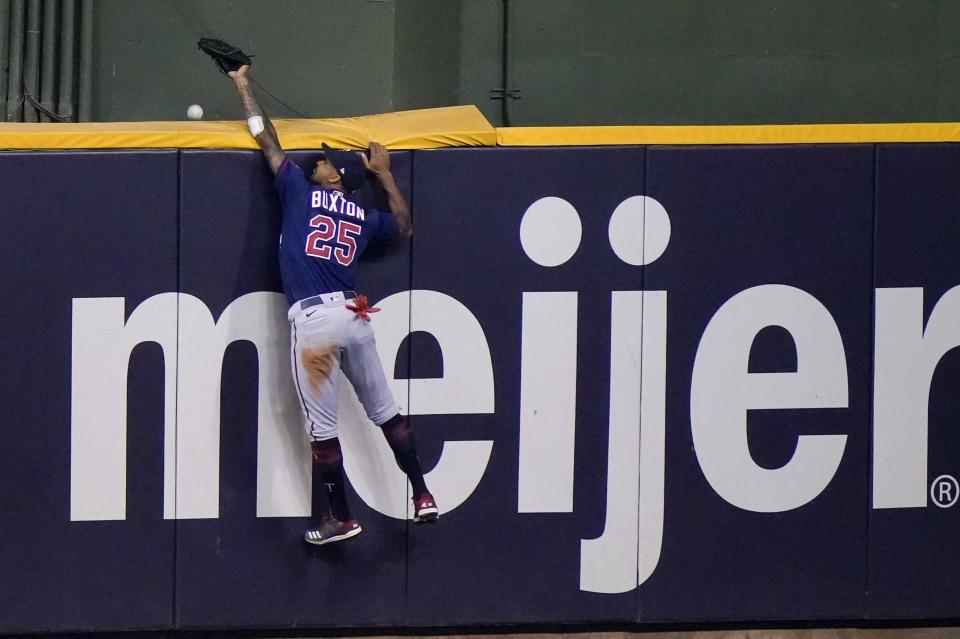 Minnesota Twins' Byron Buxton can't catch a two-run home run hit by Milwaukee Brewers' Jedd Gyorko during the eighth inning of a baseball game Tuesday, Aug. 11, 2020, in Milwaukee. (AP Photo/Morry Gash)