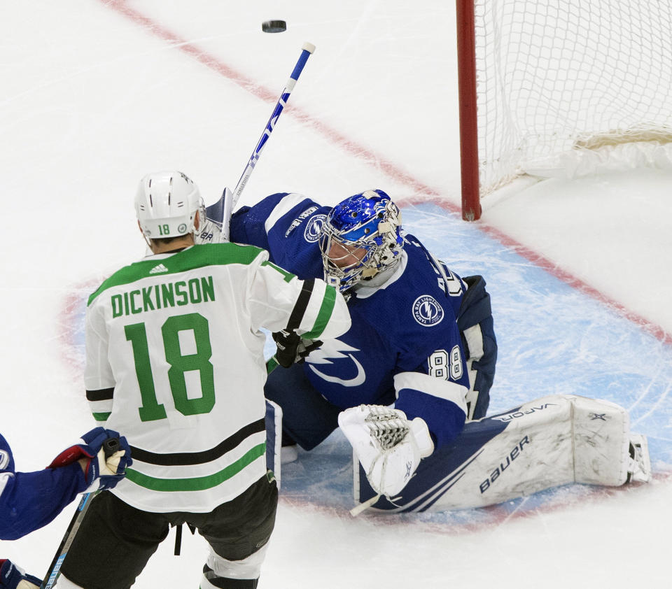 Tampa Bay Lightning goaltender Andrei Vasilevskiy (88) stops Dallas Stars center Jason Dickinson (18) during the third period of Game 5 of the NHL hockey Stanley Cup Final, Saturday, Sept. 26, 2020, in Edmonton, Alberta. (Jason Franson/The Canadian Press via AP)