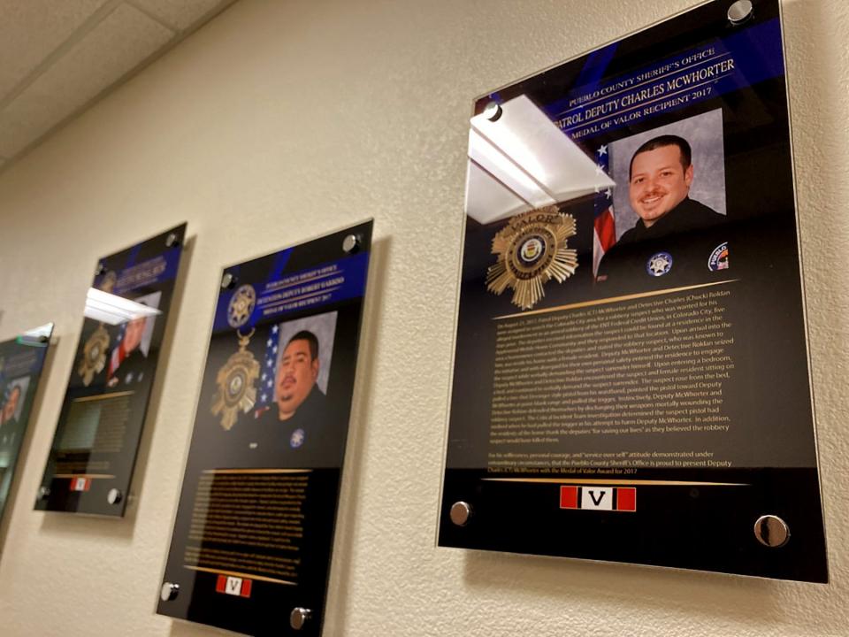 A plaque for Deputy John McWhorter's Medal of Valor award hangs at the Pueblo County Sheriff's Office Emergency Services Bureau on February 23, 2023. McWhorter was awarded the medal because of his service during another officer-involved shooting in 2017.