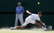 Novak Djokovic of Serbia hits a return against Roger Federer of Switzerland during their men's singles finals tennis match on Centre Court at the Wimbledon Tennis Championships in London July 6, 2014. REUTERS/Stefan Wermuth