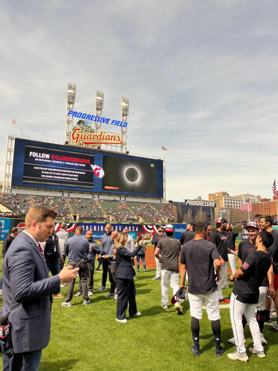 The screen at Progressive Field in Cleveland, Ohio, shows the eclipse happening in other cities.
