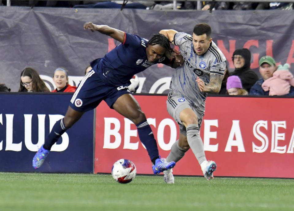 New England Revolution forward DeJuan Jones, left, and CF Montreal defender Aaron Herrera, right, chase the ball in the first half of an MLS soccer match Saturday, April 8, 2023, in Foxborough, Mass. (AP Photo/Mark Stockwell)