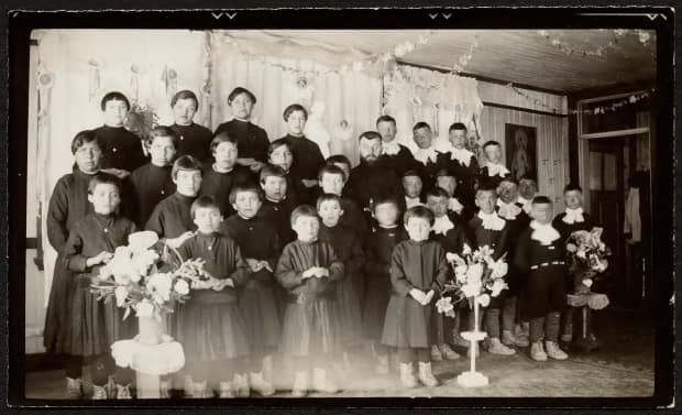 Students of the Catholic residential school at Fort George, Que., with Damase Couture, a member of the Missionary Oblates of Mary Immaculate, in 1938 or 1939. The institution operated from 1937-1981. (National Centre for Truth and Reconciliation / Deschatelets-NDC Archives  - image credit)