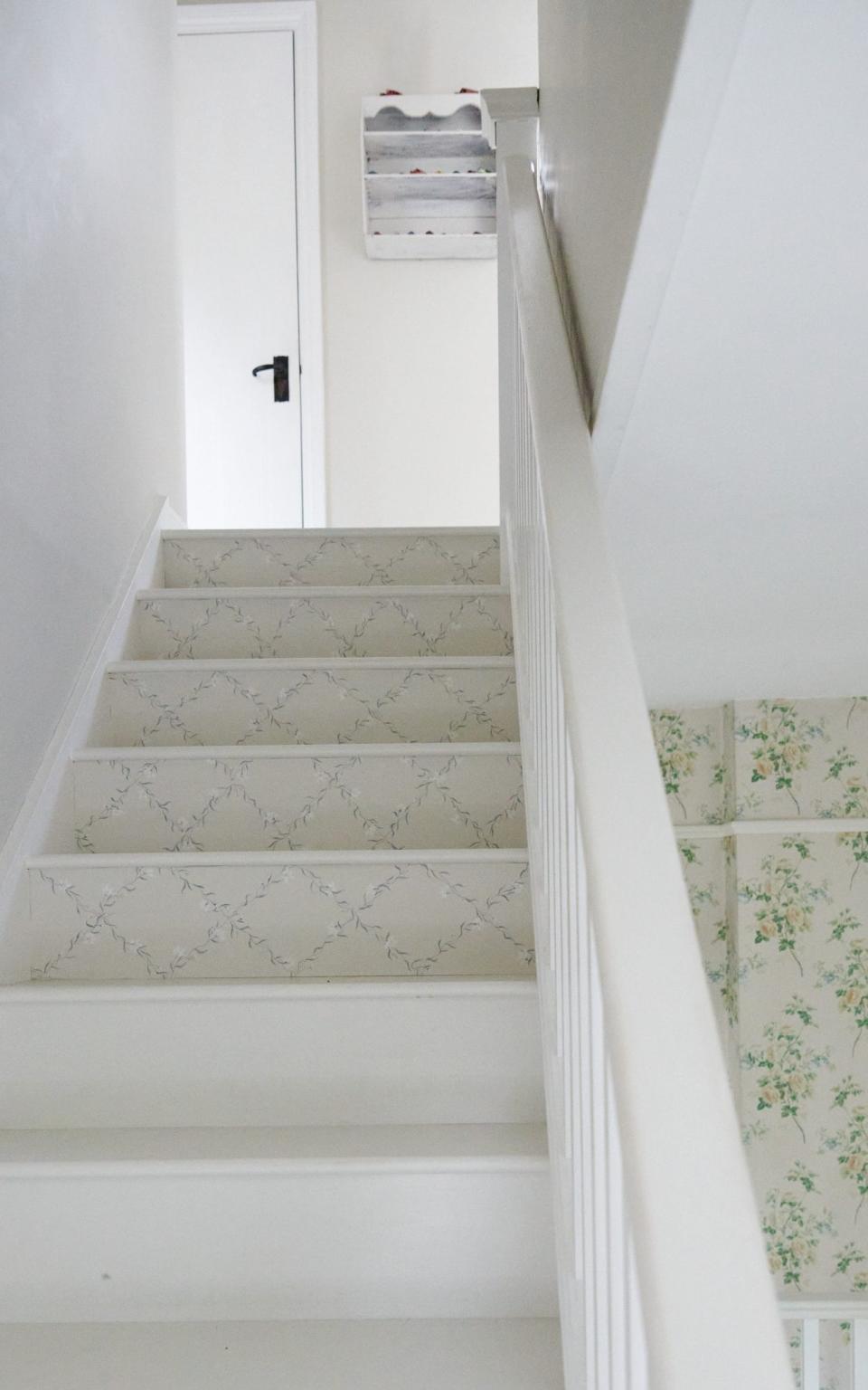 Applying wallpaper to stairs is a subtle way to add patterns or colour