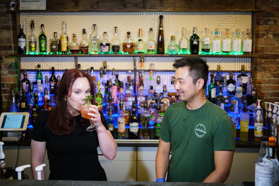 Reporter Taylor Shook takes a sip of the Eden cocktail as Josh Choi, owner of Winterbloom, looks on.