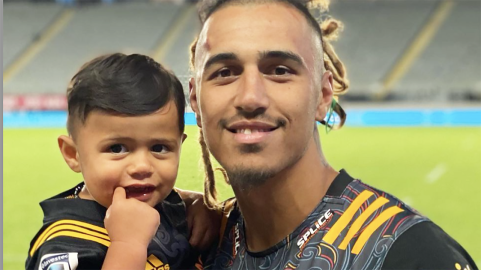 New Zealand rugby player Sean Wainui is seen with his son after a Super Rugby match for the Chiefs.