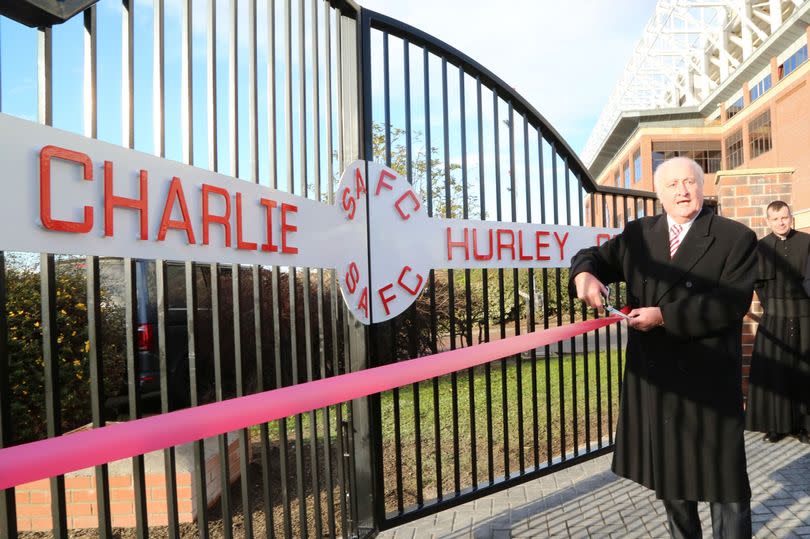 Sunderland legend Charlie Hurley poses with the old training ground gates that bear his name