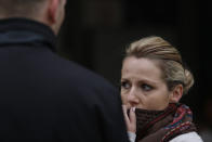 Bosnian woman Denisa Hegic reacts as she enters at the Sejkovaca identification center, near the Bosnian town of Sanski Most, 260 kilometers (162 miles) northwest of Sarajevo ,on Wednesday, April 16, 2014. Denisa Hegic was eight when Serb soldiers stormed her house and killed her entire family at the beginning of the 1992-95 Bosnian war. An aunt pulled her away from her mother's bloody body and they tried to run away, were caught but escaped again. After 22 years, Hegic reunited with her family on Wednesday at the freezing mortuary where the remains of hundreds of Muslim Bosniaks killed during the Bosnain Serb ethnic killings campaign are stored after they were excavated from Bosnia's biggest mass grave. (AP Photo/Amel Emric)