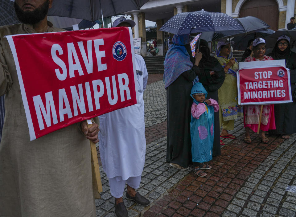 FILE- Activists protesting ethnic violence and mob assault of women who were paraded naked in northeastern Manipur state hold placards in Mumbai, India, July 23, 2023. For three months, Indian Prime Minister Narendra Modi has been largely silent on ethnic violence that has killed over 150 people in Manipur. That's sparked a no-confidence motion against his government in Parliament, where his party and allies hold a clear majority. (AP Photo/Rafiq Maqbool, File)