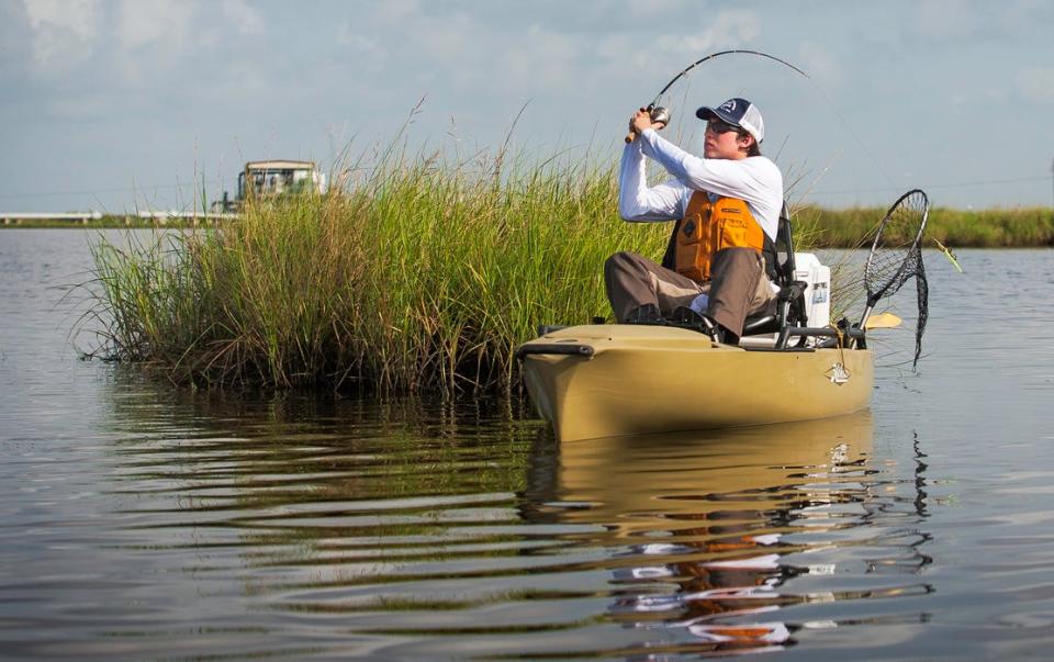 An angler fishes from a kayak in Pointe-aux-Chenes.