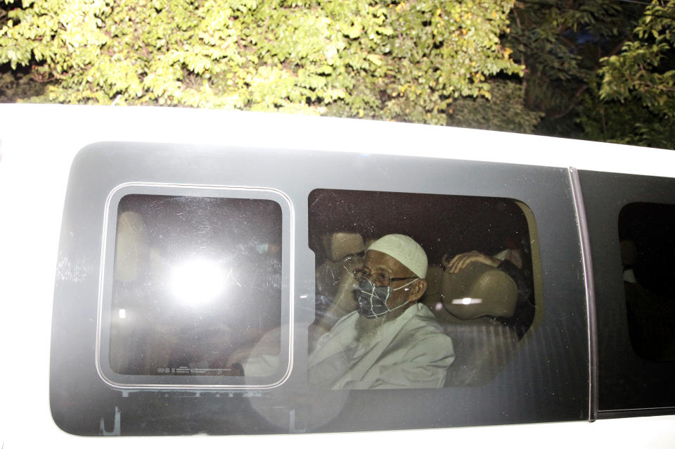 Islamic cleric Abu Bakar Bashir sits inside a van as he leaves upon his release from Gunung Sindur Prison in Bogor, West Java, Indonesia, Friday, Jan. 8, 2021. The convicted firebrand cleric who inspired the Bali bombers and other violent extremists walked free from prison Friday after completing his sentence for funding the training of Islamic militants. (AP Photo/Aditya Irawan)