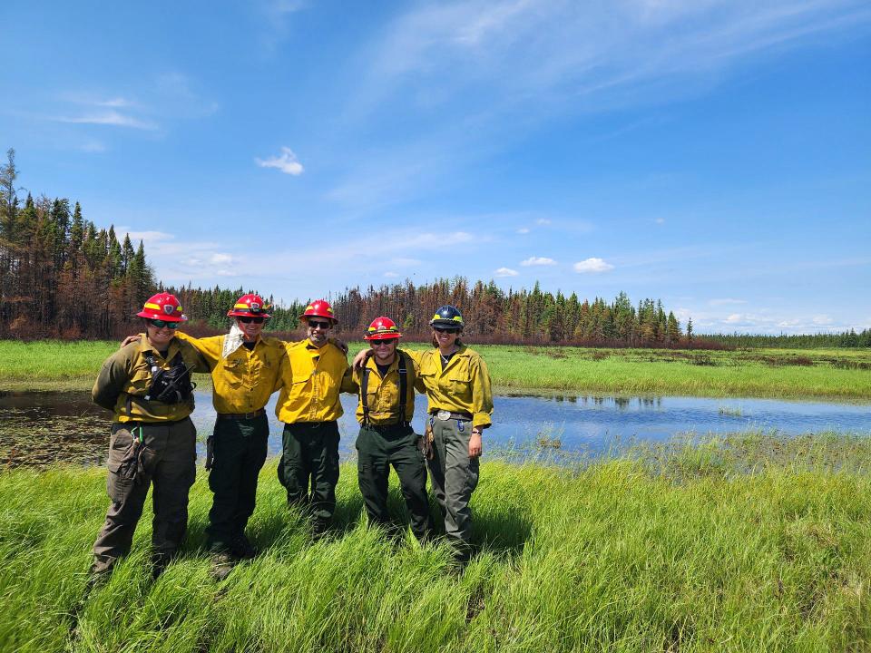 Massachusetts Department Conservation and Recreation firefighter Nicole Madden, left, is photographed with other crew members during her deployment to Normétal, Canada, to help with the wildfires. From left to right, are Madden, Owen Looby, Ben Mazzei, Brian Procida and Abbie Merchant. The crew had hiked out to this location where they would be picked up by helicopter. Madden, Looby and Procida work for the state Department of Conservation and Recreation. Ben Mazzei works for the state Division of Fish and Wildlife. Merchant works for the Connecticut Department of Energy and Environmental Protection.