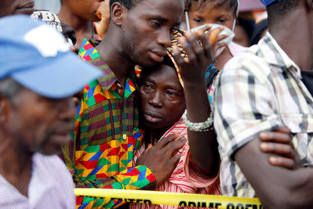 A mother who lost her son during the mudslide gets consoled by a sympathiser near the entrance of Connaught Hospital in Freetown, Sierra Leone August 16, 2017. REUTERS/Afolabi Sotunde