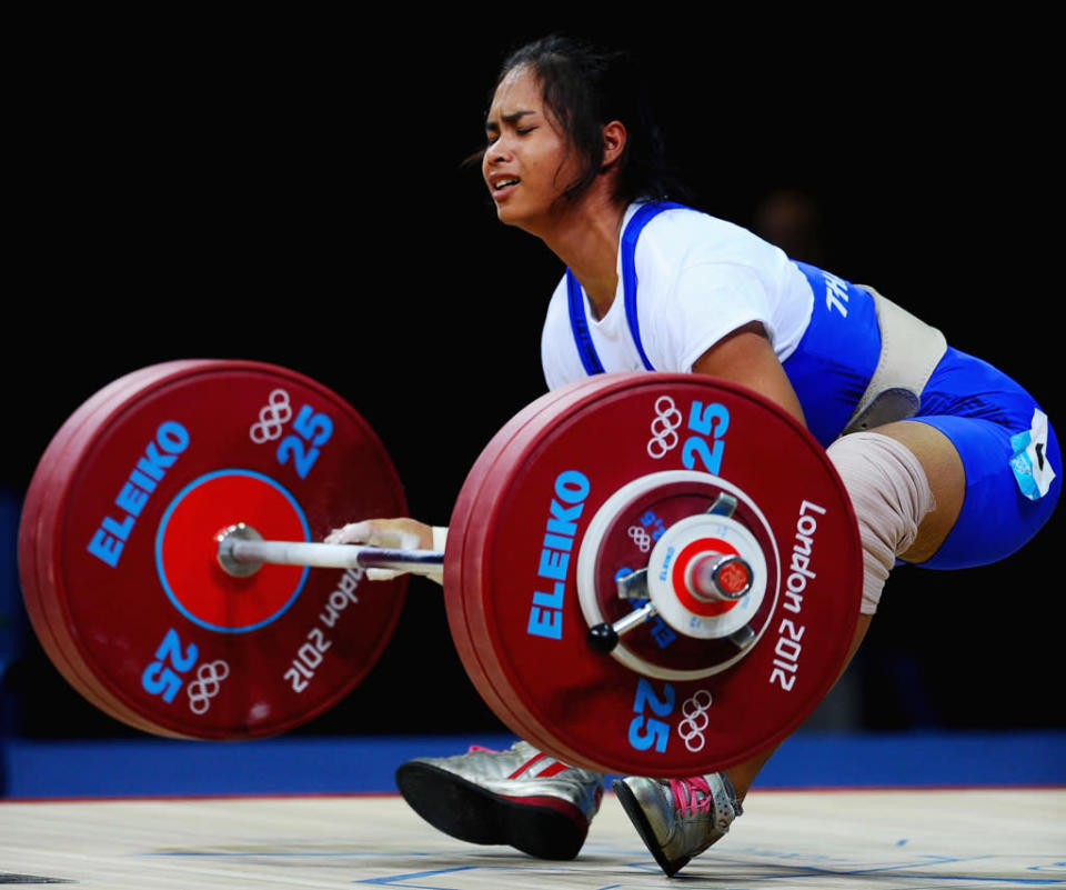 Rattikan Gulnoi of Thailand falls while competing in the Women's 58kg Weightlifting on Day 3 of the London 2012 Olympic Games at ExCeL on July 30, 2012 in London, England. (Photo by Laurence Griffiths/Getty Images)