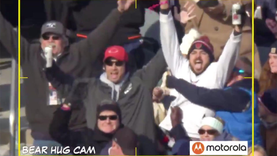 The group of four fans completely obstruct the newly-engaged couple. Pic: @ChicagoBears