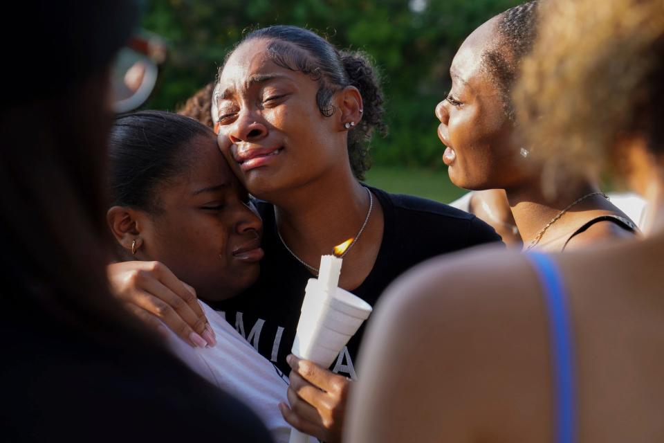 Jaia Brown, center, gets emotional as she is comforted by friends during a vigil honoring Khalil Amari Allen, 18, in Southfield on Friday, July 14, 2023. Brown said Allen was her favorite cousin. Allen was shot and killed while driving to get food the evening of July 11.