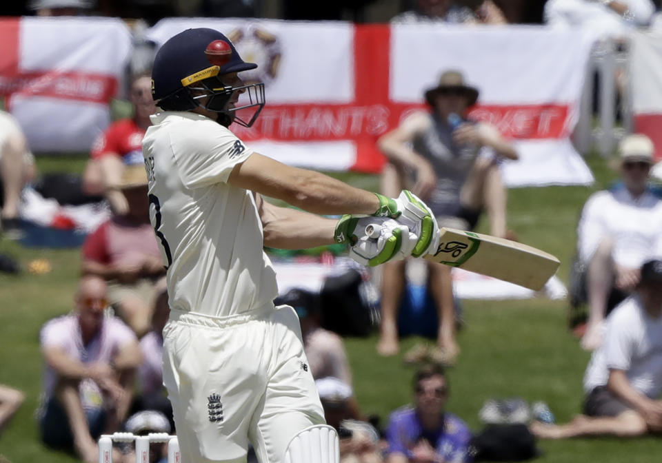 England's Jos Buttler swings at the ball during play on day two of the first cricket test between England and New Zealand at Bay Oval in Mount Maunganui, New Zealand, Friday, Nov. 22, 2019. (AP Photo/Mark Baker)