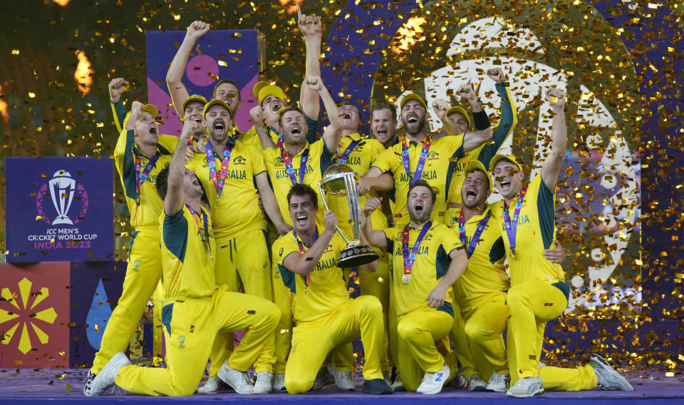 Australian players celebrate with the trophy after winning against India during the ICC Men's Cricket World Cup final match in Ahmedabad, India, Sunday, Nov.19, 2023. (AP Photo/Aijaz Rahi)