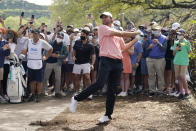 Scottie Scheffler follows through on his third shot on hole No. 6 during the final round of the Dell Technologies Match Play Championship golf tournament Sunday, March 28, 2021, in Austin, Texas. (AP Photo/David J. Phillip)