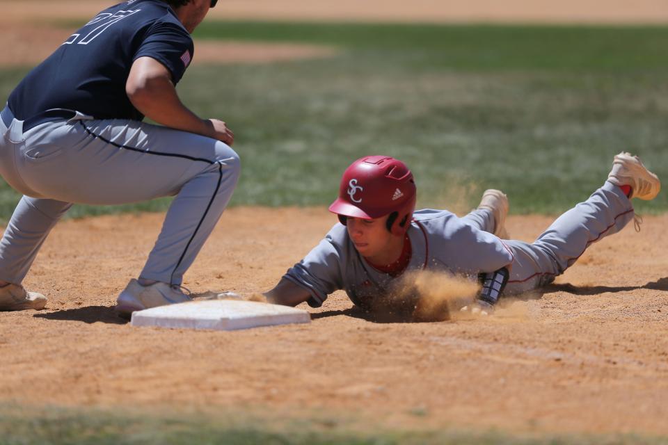 Savannah Christian's Luke Rowland dives to first ahead of the tag by Fellowship Christian's Evan Leccese.