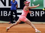 Simona Halep of Romania returns the ball to Carla Suarez Navarro of Spain during their women's semi-final match at the Rome Open tennis tournament in Rome, Italy, May 16, 2015. REUTERS/Stefano Rellandini