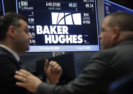 Traders work near where Baker Hughes is traded on the floor of the New York Stock Exchange (NYSE) in New York City, U.S. May 2, 2016. REUTERS/Brendan McDermid