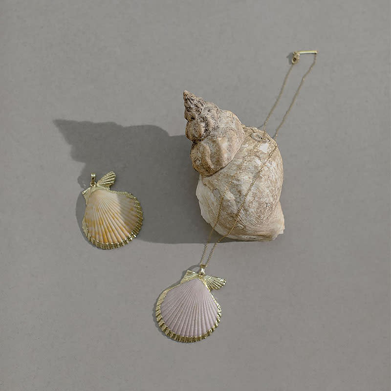 <a rel="nofollow noopener" href="https://bloomingdreamer.co.uk/collections/jewellery/products/natural-shell-pendant" target="_blank" data-ylk="slk:Sea Of Love Necklace, Blooming Dreamer, $80If you’re slowly jumping on the seashell jewelry trend, this pendant necklace is the perfect addition to your collection. This emerging brand works with sustainable materials and traditional artisans from London and around the world. Plus, each design is handcrafted in small batches, meaning your piece will be rare and distinctive.;elm:context_link;itc:0;sec:content-canvas" class="link ">Sea Of Love Necklace, Blooming Dreamer, $80<p>If you’re slowly jumping on the seashell jewelry trend, this pendant necklace is the perfect addition to your collection. This emerging brand works with sustainable materials and traditional artisans from London and around the world. Plus, each design is handcrafted in small batches, meaning your piece will be rare and distinctive.</p> </a>