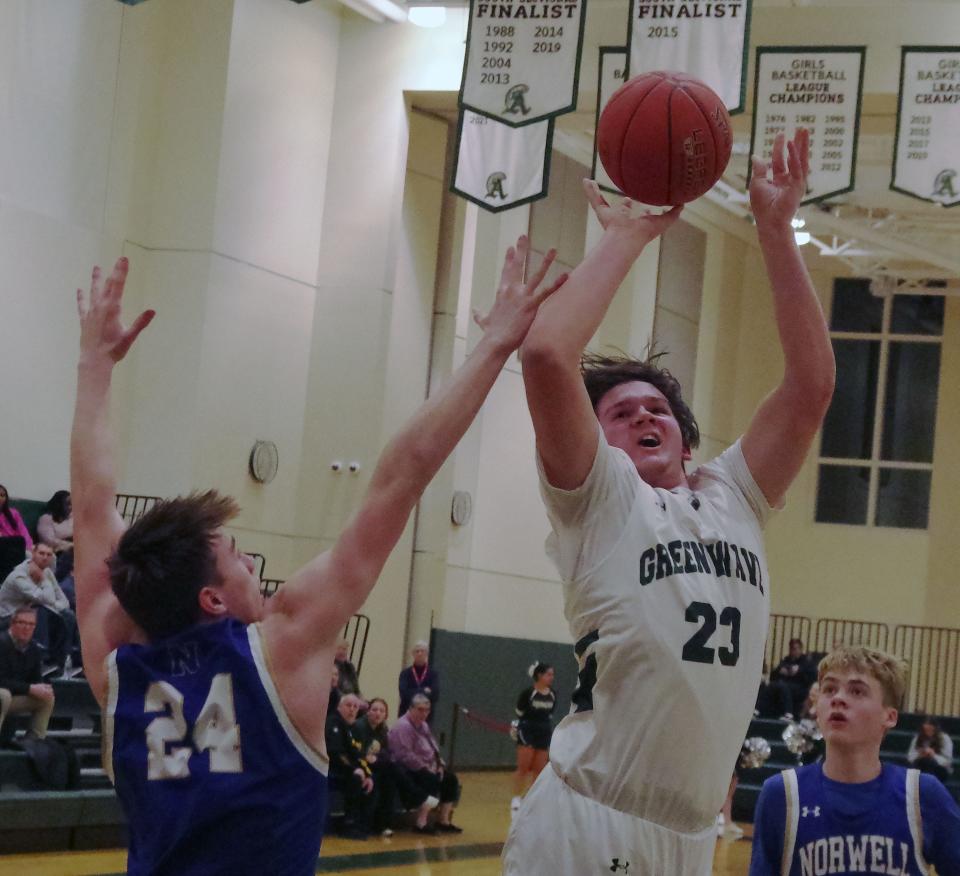 Abington co-captain Connor Pease goes up to the basket for a shot in the 1st half the game against Jack Luccarelli of Norwell (#24, L) on Wednesday, Jan. 31, 2024.