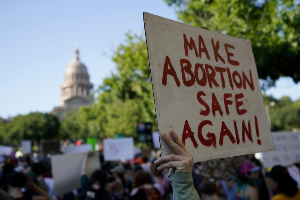 Sign held up: "Make abortion safe again!"