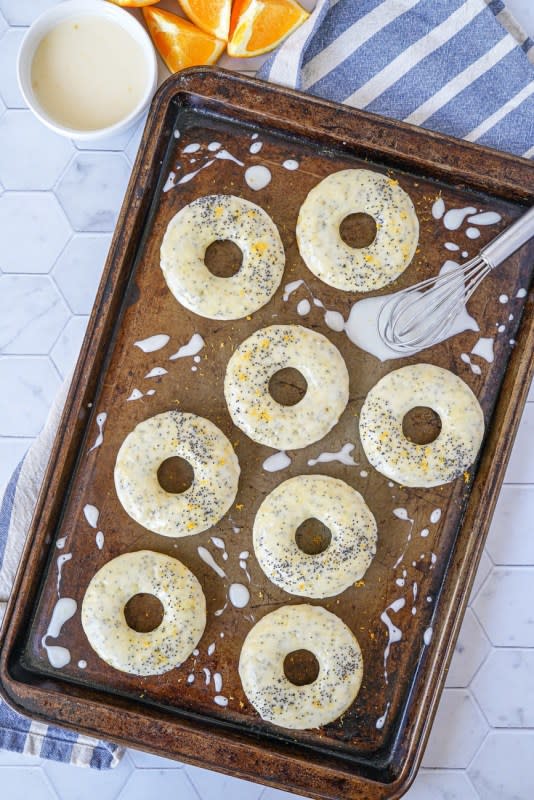 <p>A recipe for orange poppy seed baked doughnuts! These light, citrus-scented baked donuts are topped with a sweet orange glaze and even more poppy seeds for an easy and flavorful addition to brunch.</p><p><strong>Get the recipe: <a href="https://tarasmulticulturaltable.com/orange-poppy-seed-baked-doughnuts/" rel="nofollow noopener" target="_blank" data-ylk="slk:Orange Poppy Seed Baked Doughnuts;elm:context_link;itc:0;sec:content-canvas" class="link rapid-noclick-resp"><em>Orange Poppy Seed Baked Doughnuts</em></a></strong></p>