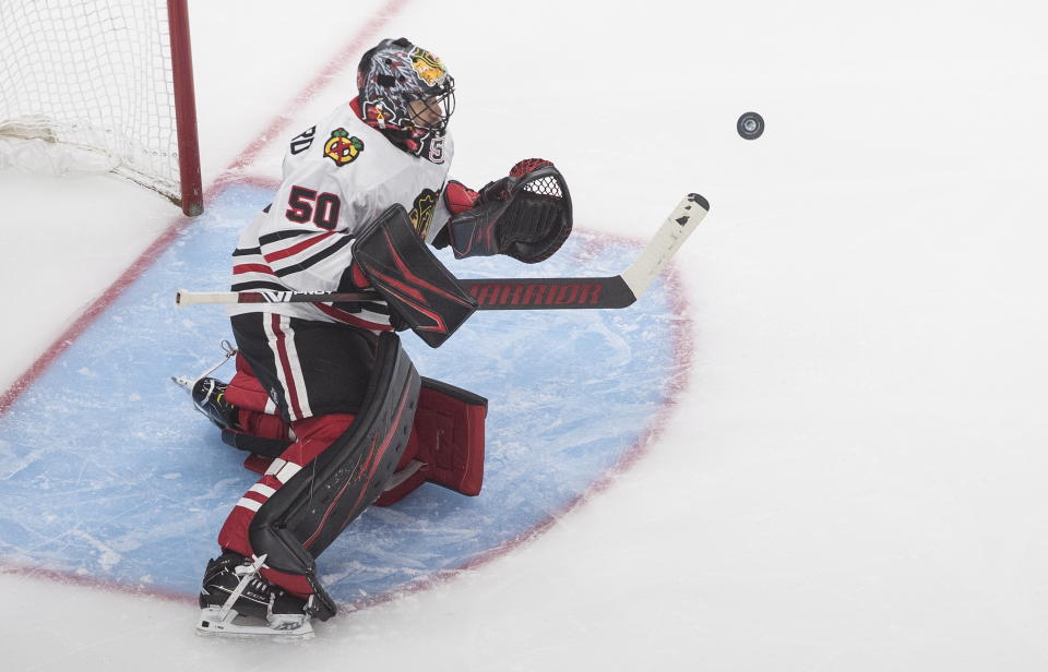 Chicago Blackhawks goalie Corey Crawford (50) makes a save against the Edmonton Oilers during the third period of an NHL hockey playoff game in Edmonton, Alberta, Saturday, Aug. 1, 2020. (Jason Franson/The Canadian Press via AP)