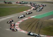 Mercedes driver Lewis Hamilton of Britain (lower R) leads the pack on the second corner during the Formula One Chinese Grand Prix in Shanghai on April 20, 2014