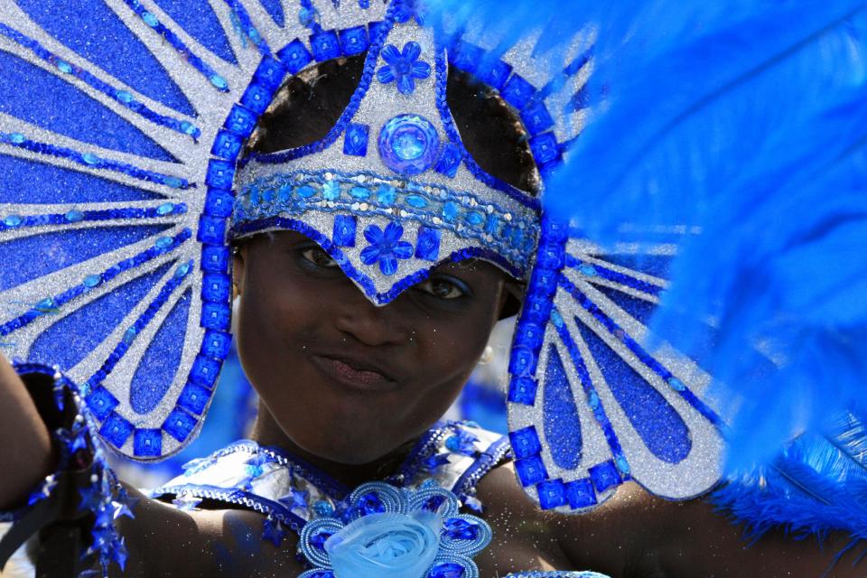 A performer walks through the street during Lagos Carnival in Lagos, Nigeria, on Monday, April 1, 2013. Performers filled the streets of Lagos' islands Monday as part of the Lagos Carnival, a major festival in Nigeria's largest city during Easter weekend. (AP Photo/Jon Gambrell)