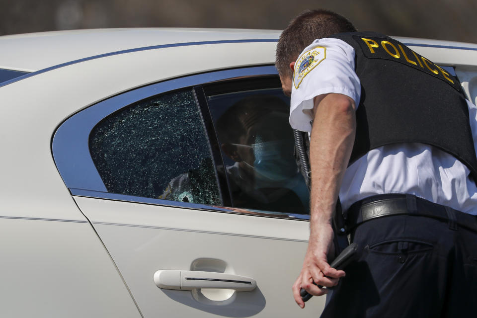 Chicago police investigate the scene of a shooting where a 2-year-old boy was shot in the head while he was traveling inside a car near Grant Park, Tuesday, April 6, 2021. (Jose M. Osorio/Chicago Tribune via AP)