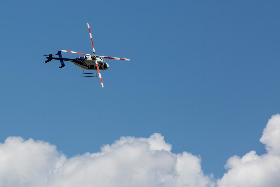 A new helicopter hovers above the Collier Mosquito Control District on Wednesday, July 17, 2019. The helicopter will replace two older aircraft used in aerial spraying to fight mosquitoes.