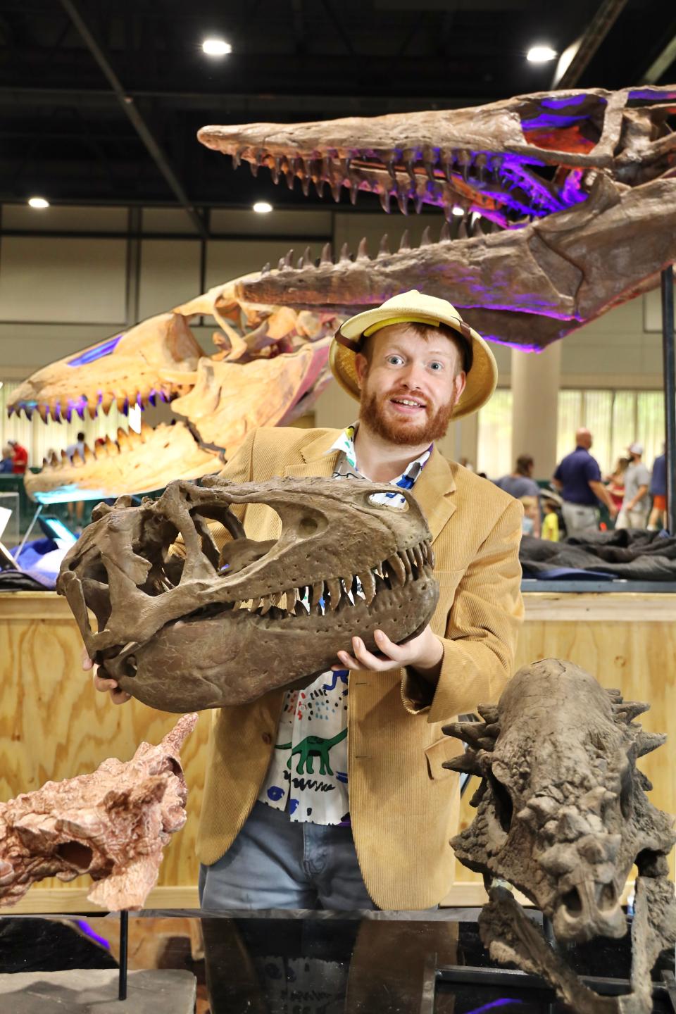 Jurassic Quest dinosaur expert Nick Schaefer — aka “Prehistoric Nick" — poses with some dino fossils.