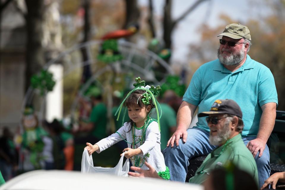 FILE - Sarah Ann Phillips, 5, holds out her bag for candy during the St. Patrick's Day parade in downtown Augusta on Thursday, March 17, 2022. The parade returns Friday.