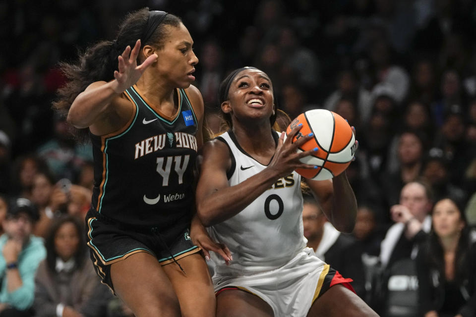 New York Liberty's Betnijah Laney (44) defends Las Vegas Aces' Jackie Young (0) during the second half in Game 4 of a WNBA basketball final playoff series Wednesday, Oct. 18, 2023, in New York. The Aces won 70-69. (AP Photo/Frank Franklin II)