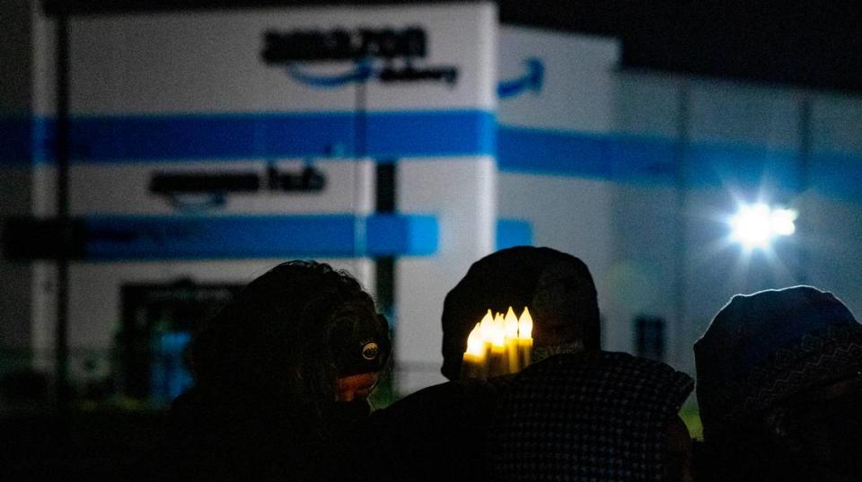 A person holds six battery-operated candles at a vigil last month, symbolizing the six workers killed on Dec. 10, 2021, at an Amazon warehouse in Edwardsville that collapsed due to a tornado.