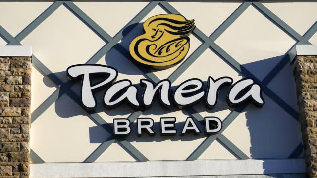 A Panera Bread logo is attached to the outside of a Panera Bread restaurant location.