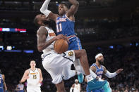 New York Knicks guard Frank Ntilikina (11) fouls Denver Nuggets guard Will Barton during the first half of an NBA basketball game Thursday, Dec. 5, 2019, at Madison Square Garden in New York. (AP Photo/Mary Altaffer)