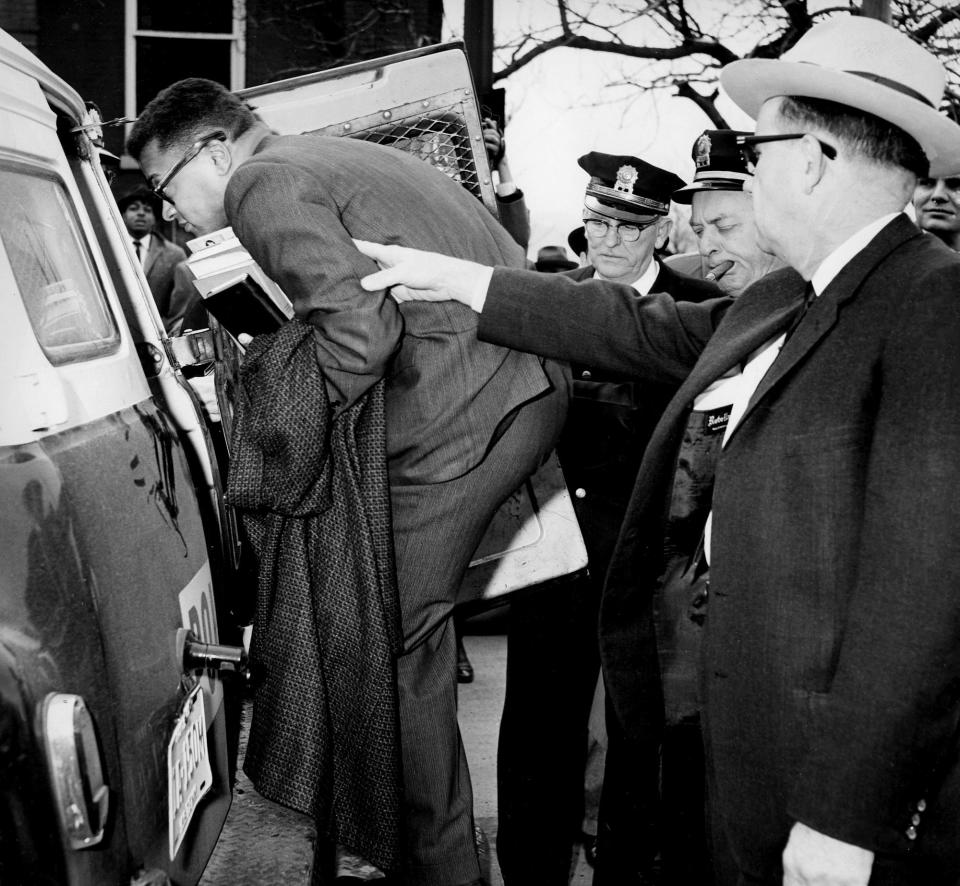 With an arrest warrant in hand, Nashville police direct the Rev. James Lawson, left, expelled Vanderbilt University divinity student, into the paddy wagon in front of the First Baptist Church on March 4, 1960. Lawson was arrested on charges of conspiring to violate the state's trade and commerce law.